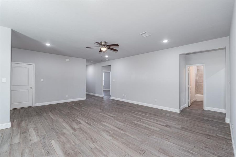 Spare room featuring visible vents, baseboards, a ceiling fan, and light wood-style floors