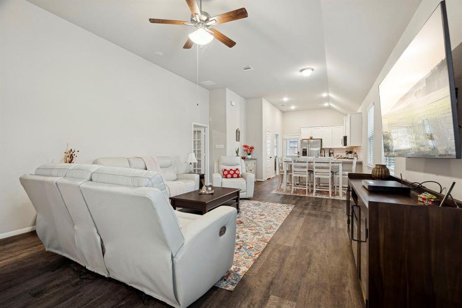 Kitchen seamlessly flows into the living room, which is spacious and bright, offering plenty of room for both relaxation and entertainment.