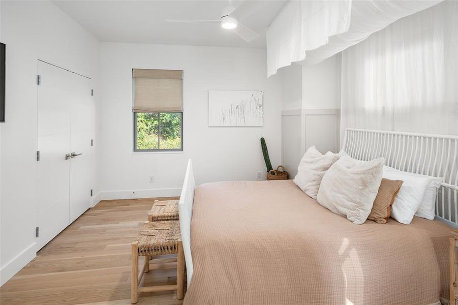 Bedroom featuring ceiling fan and light wood-type flooring Bedroom featuring ceiling fan and light wood-type flooring