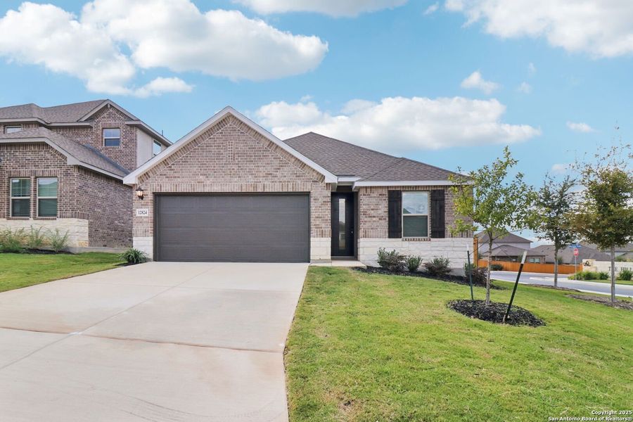 Front exterior of a new home in Arcadia Ridge - Premier Series, San Antonio, TX, highlighting curb appeal (Image 19).