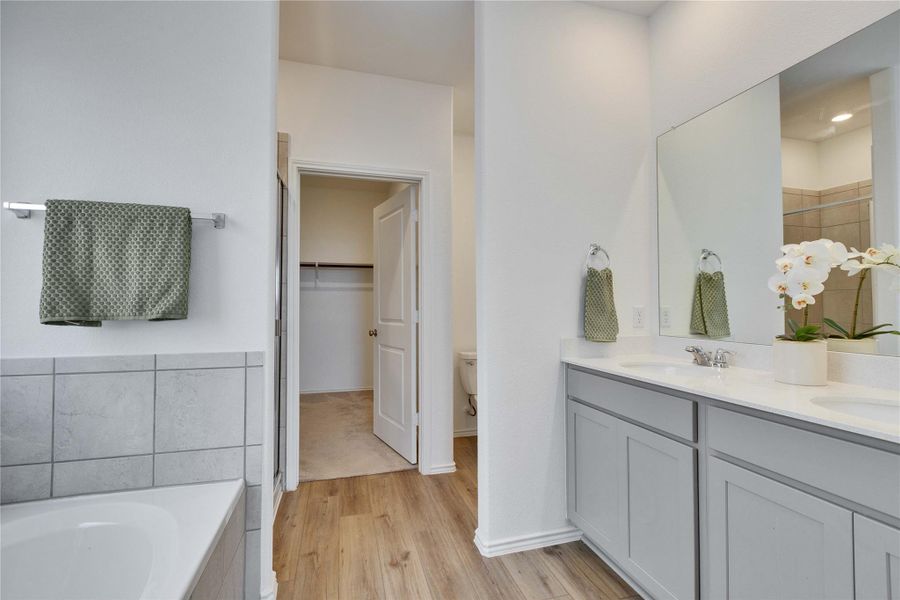 Full bath in primary with a glass stall shower and bathtub. Full bath in primary with a glass stall shower and bathtub.