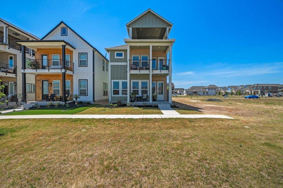 Striking modern architecture defines this multi-level home featuring prominent covered balconies and clean vertical siding. Striking modern architecture defines this multi-level home featuring prominent covered balconies and clean vertical siding.