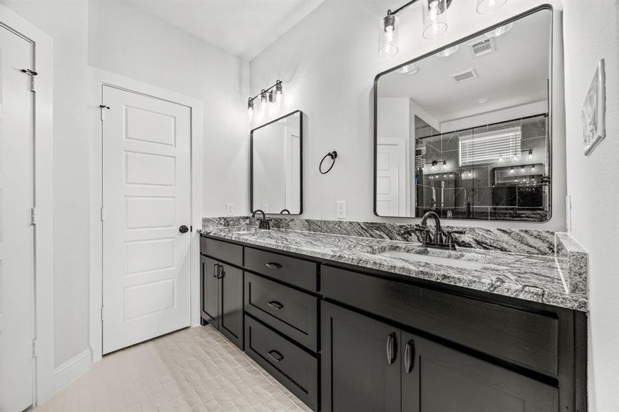 Bathroom with vanity and a shower with door