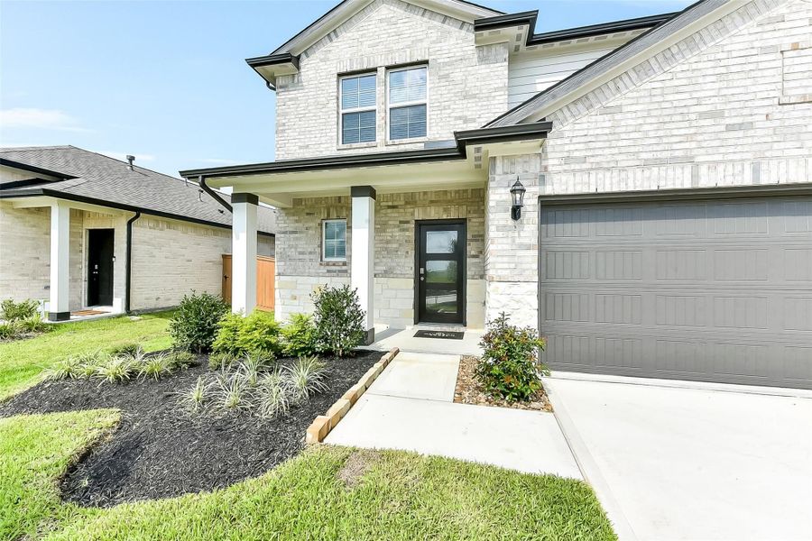 Front exterior of a new home in River Ranch Meadows, Dayton, TX, highlighting curb appeal (Image 20).