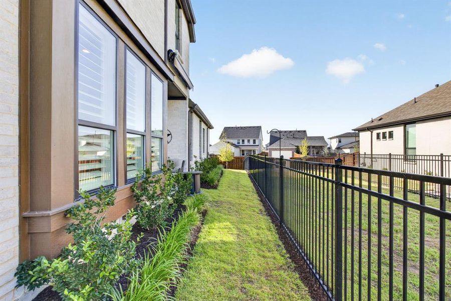 The pretty landscaping carries all the way down the side yard. So charming. The pretty landscaping carries all the way down the side yard. So charming.