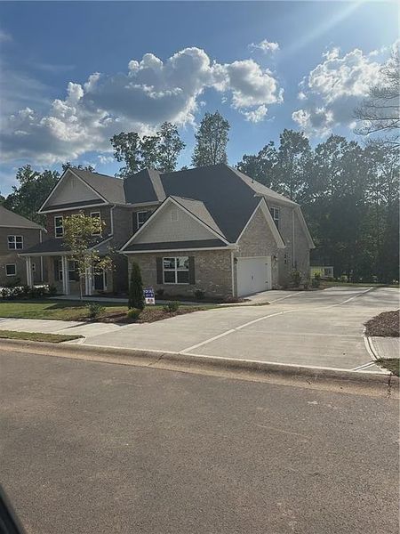 Front exterior of a new home in Mirror Lake at South Harbour, Villa Rica, GA, highlighting curb appeal (Image 2).