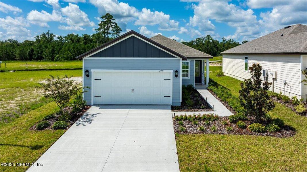 Front exterior of a new home in Jennings Farm, Middleburg, FL, highlighting curb appeal (Image 1). Front exterior of a new home in Jennings Farm, Middleburg, FL, highlighting curb appeal (Image 1).