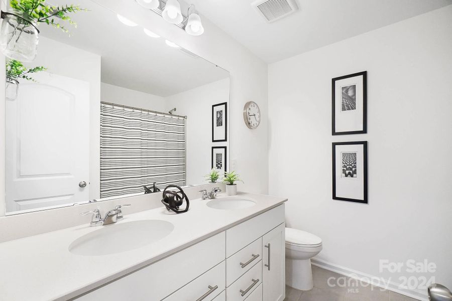 Full bathroom with double sinks upstairs.