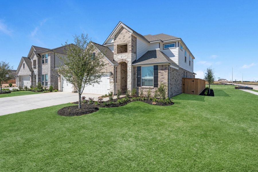 Front exterior of a new home in Sunterra Lakes, Brookshire, TX, highlighting curb appeal (Image 22).
