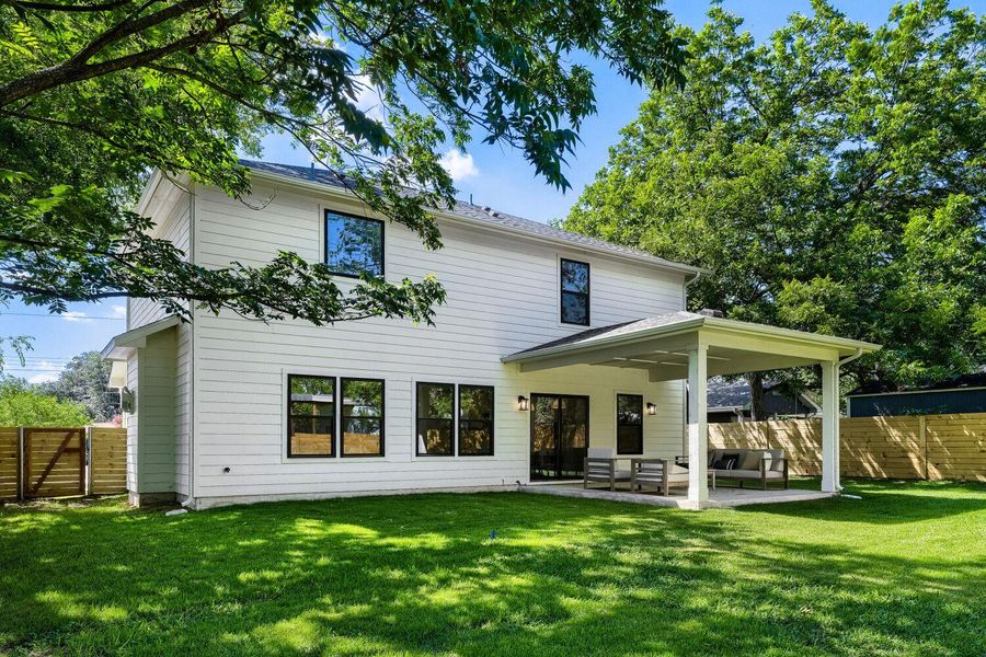 A private backyard oasis with a covered patio, perfect for outdoor living. A private backyard oasis with a covered patio, perfect for outdoor living.