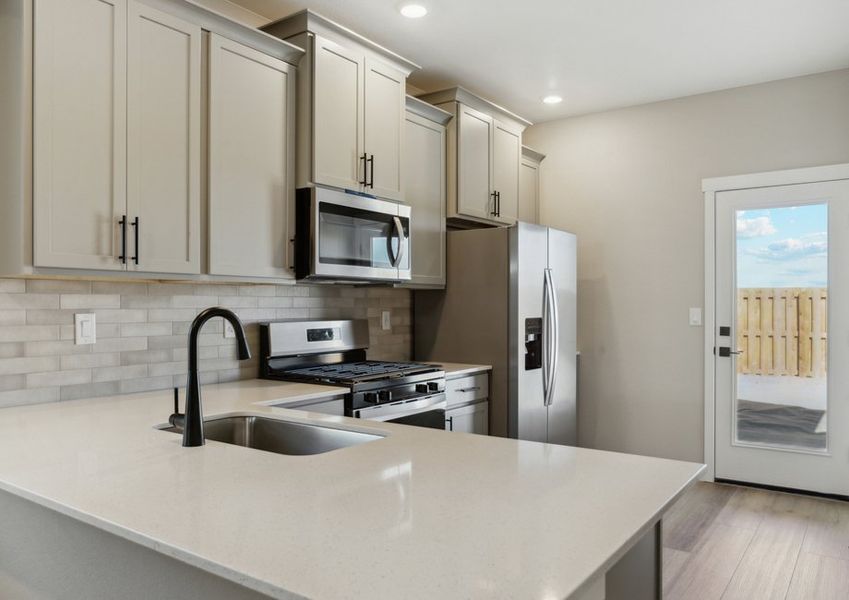 The kitchen has stainless steel appliance and plank flooring.