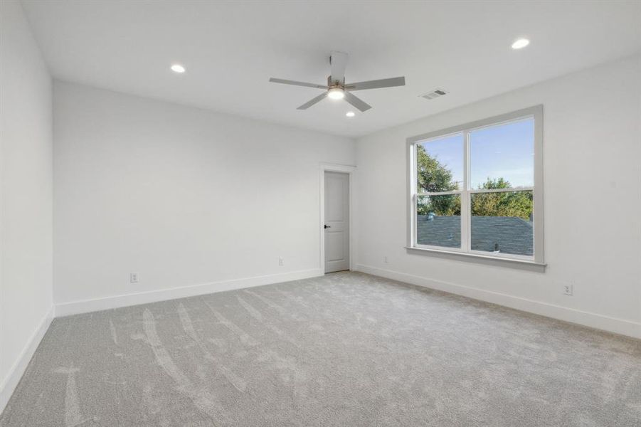 Unfurnished room featuring ceiling fan and light colored carpet