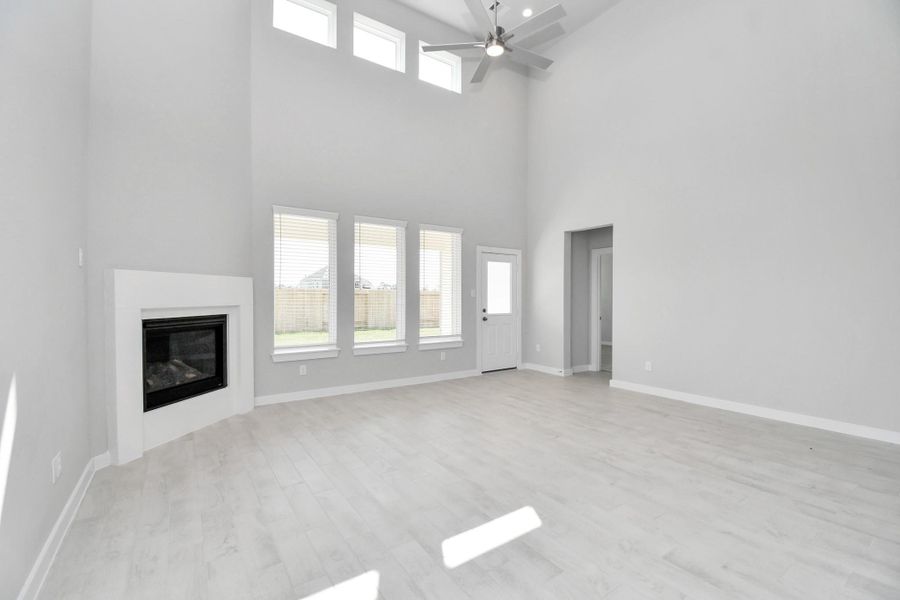 Family room flooded with natural light through the expansive windows. The premium tile flooring adds a touch of luxury to the space, creating the perfect setting for relaxing moments and cherished gatherings with loved ones. Sample photo of completed home with similar floor plan. Actual colors and selections may vary. Family room flooded with natural light through the expansive windows. The premium tile flooring adds a touch of luxury to the space, creating the perfect setting for relaxing moments and cherished gatherings with loved ones. Sample photo of completed home with similar floor plan. Actual colors and selections may vary.