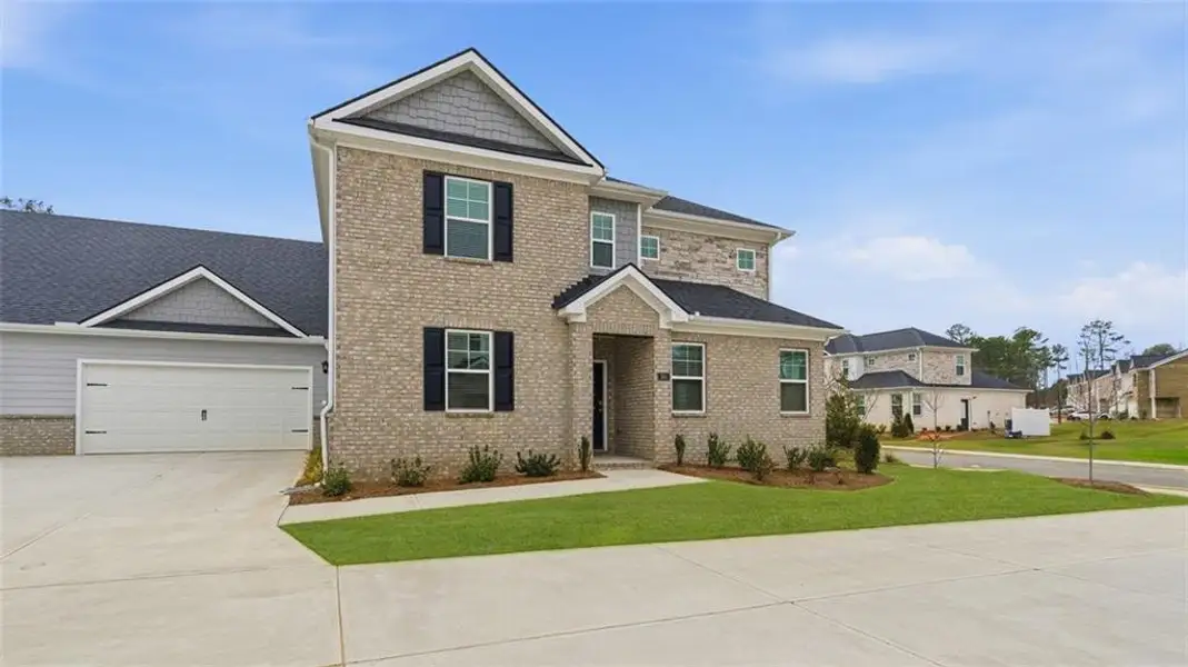 Front exterior of a new home in Independence Villas and Townhomes, Loganville, GA, highlighting curb appeal (Image 19). Front exterior of a new home in Independence Villas and Townhomes, Loganville, GA, highlighting curb appeal (Image 19).