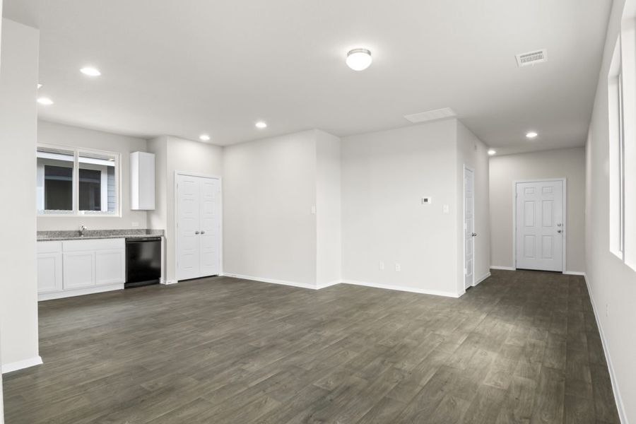 Image of a one story living room with brown flooring and grey walls