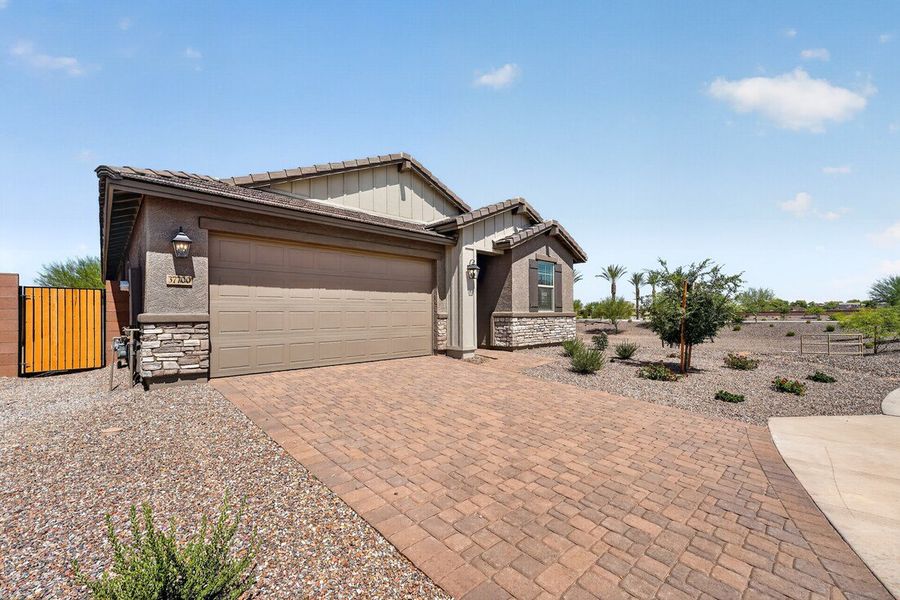 Front exterior of a new home in Combs Ranch, San Tan Valley, AZ, highlighting curb appeal (Image 2). Front exterior of a new home in Combs Ranch, San Tan Valley, AZ, highlighting curb appeal (Image 2).