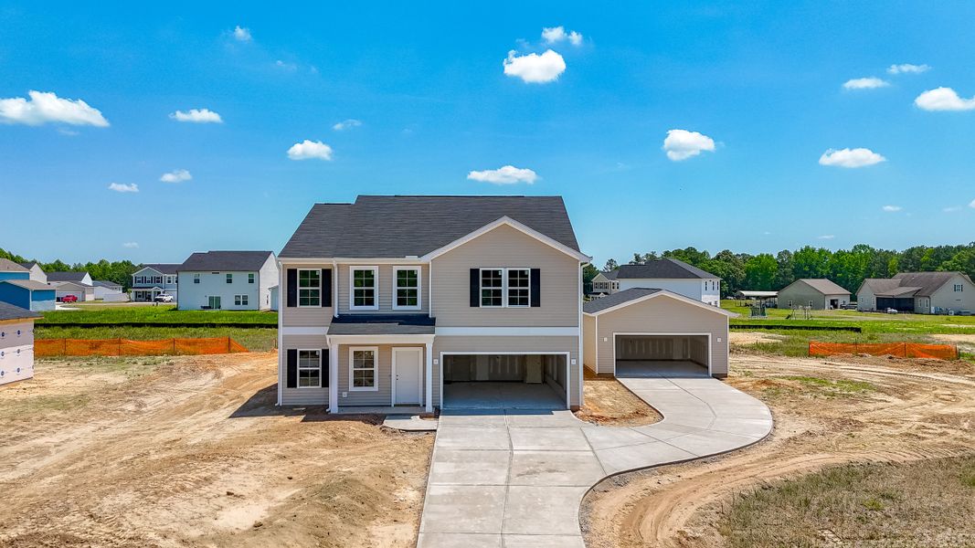 Front exterior of a new home in Cambridge Reserve, Angier, NC, highlighting curb appeal (Image 1). Front exterior of a new home in Cambridge Reserve, Angier, NC, highlighting curb appeal (Image 1).