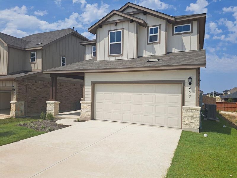 Front exterior of a new home in Sunfield, Buda, TX, highlighting curb appeal (Image 18). Front exterior of a new home in Sunfield, Buda, TX, highlighting curb appeal (Image 18).