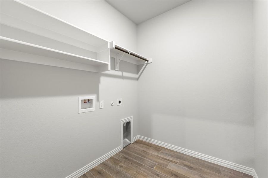 Laundry area featuring electric dryer hookup, wood finished floors, hookup for a washing machine, and hookup for a gas dryer Laundry area featuring electric dryer hookup, wood finished floors, hookup for a washing machine, and hookup for a gas dryer