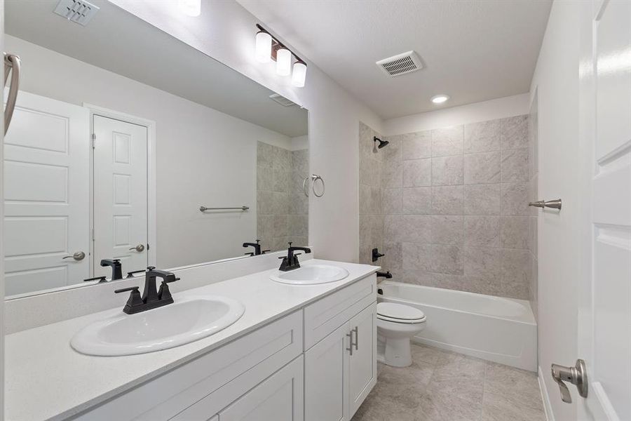 Guests will enjoy their own vanity space in this thoughtfully designed guest bath.