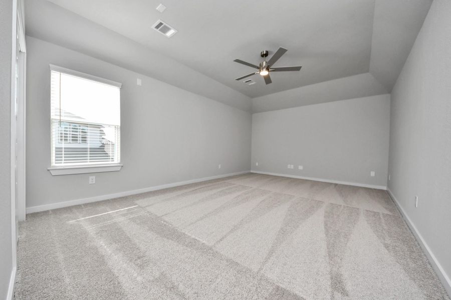 Secondary bedroom features plush carpeting, large windows that let in plenty of natural light, bright paint, and spacious closets.