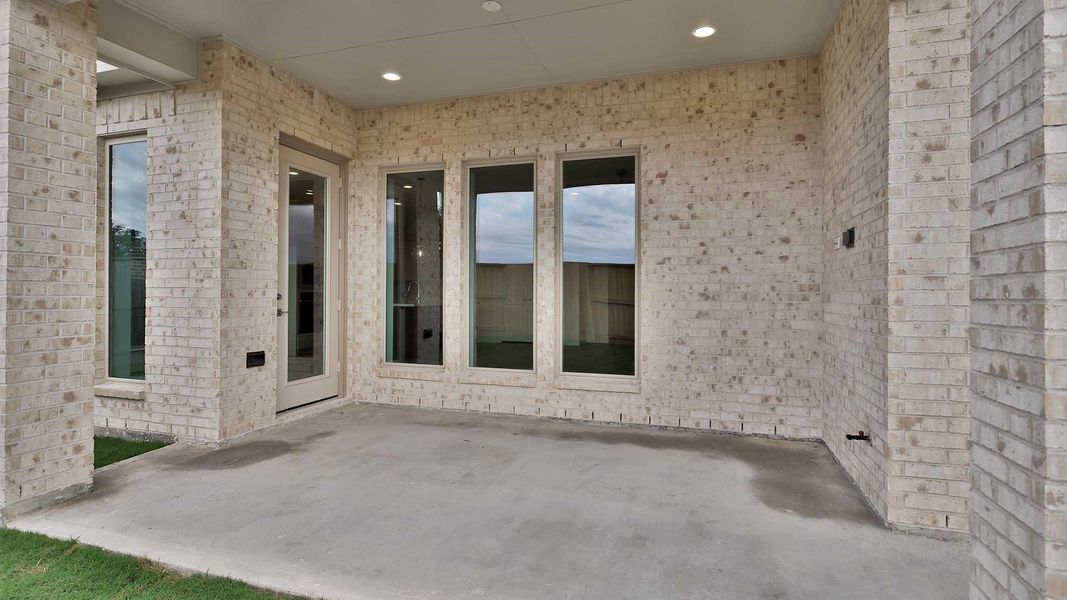 Exterior details and patio area of a home in Serenity 55+ Active Adult, Manvel (Image 3).