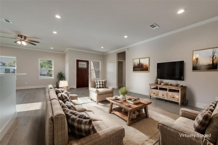 Living room with ceiling fan, crown molding, and hardwood / wood-style flooring