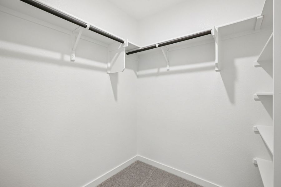 A white staircase with a metal railing.