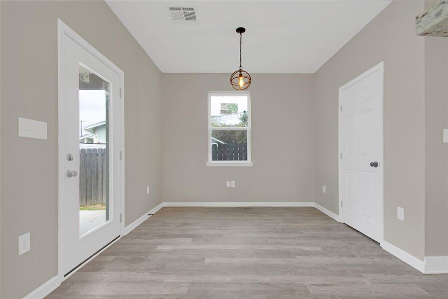 Unfurnished dining area with light wood-style floors