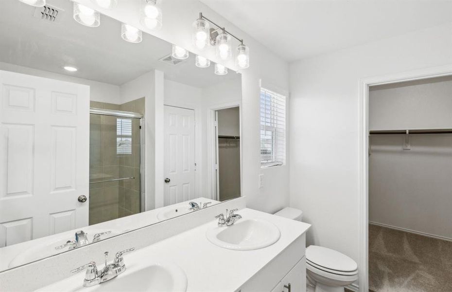 Owner's bath with dual vanity and large shower *real home pictured