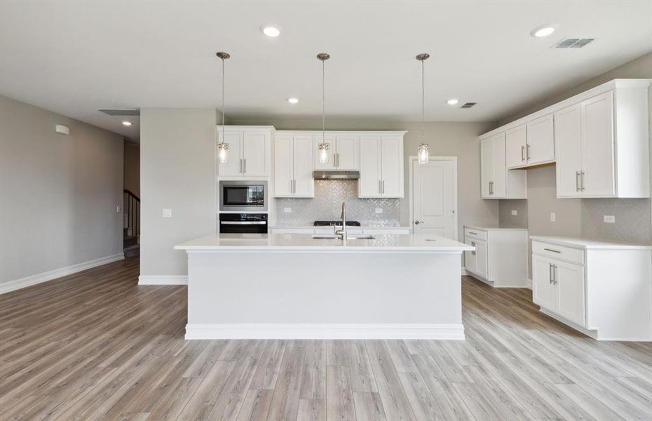 Airy kitchen with large island *real home pictured