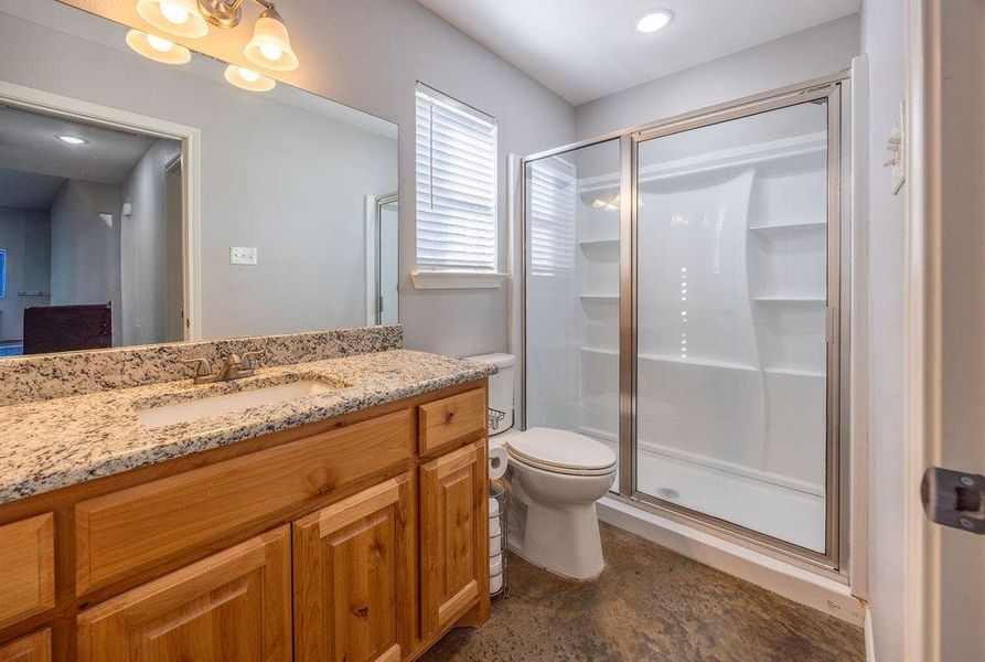 Full bath featuring vanity, a shower stall, and recessed lighting