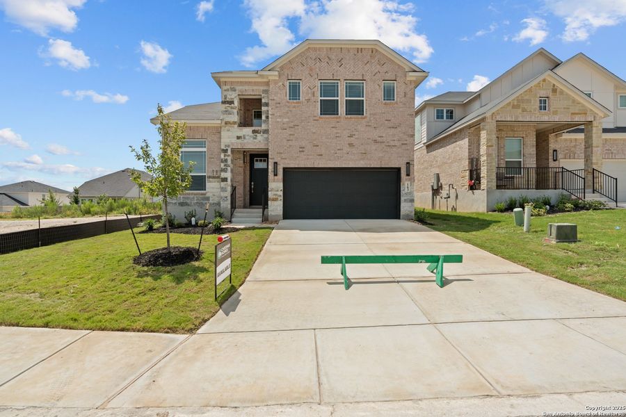 Front exterior of a new home in Hunters Ranch, San Antonio, TX, highlighting curb appeal (Image 2). Front exterior of a new home in Hunters Ranch, San Antonio, TX, highlighting curb appeal (Image 2).