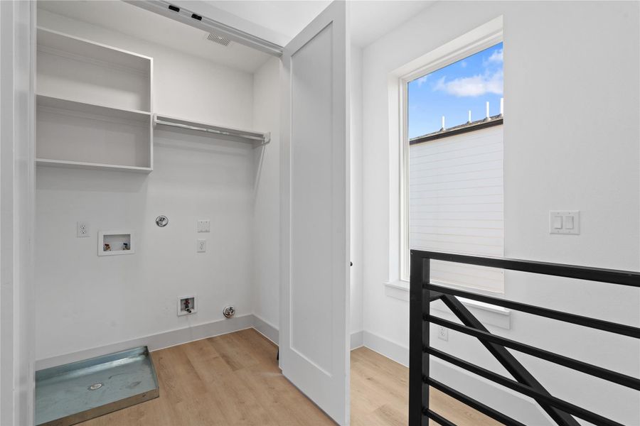 Laundry becomes effortless with a utility room located steps from the primary suite. Laundry becomes effortless with a utility room located steps from the primary suite.