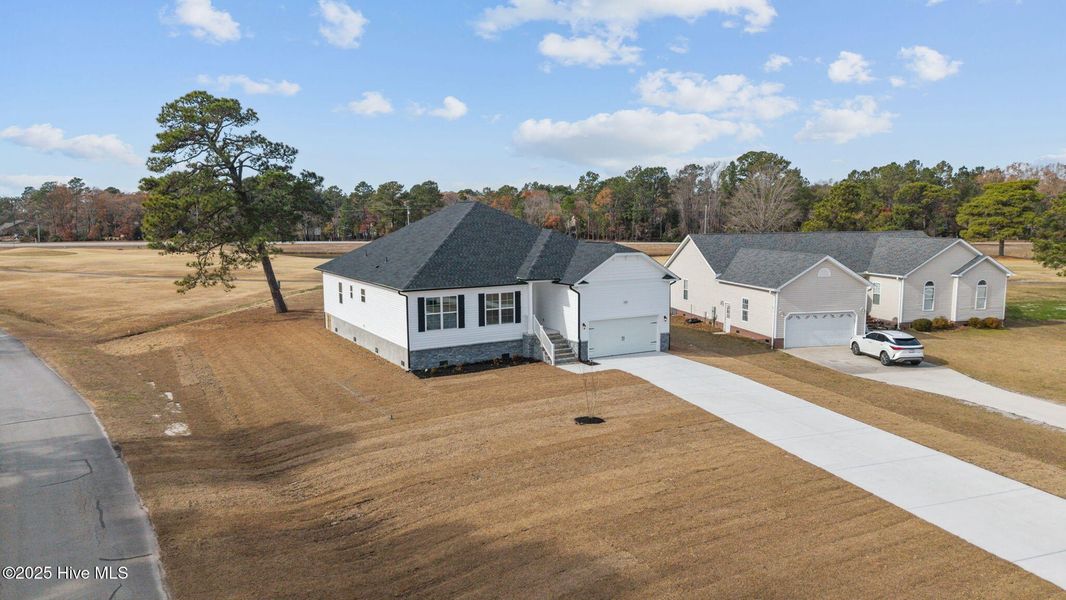 Front exterior of a new home in Fairfield Harbour, New Bern, NC, highlighting curb appeal (Image 2). Front exterior of a new home in Fairfield Harbour, New Bern, NC, highlighting curb appeal (Image 2).