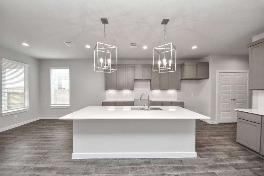 This kitchen is by far any chef’s dream! This spacious kitchen features high ceilings, stained wood cabinets, granite countertop, SS appliances, modern tile backsplash, recessed lighting, extended counter space, granite kitchen island with double sink, and space for breakfast bar, and a walk-in pantry all overlooking your huge family room. This kitchen is by far any chef’s dream! This spacious kitchen features high ceilings, stained wood cabinets, granite countertop, SS appliances, modern tile backsplash, recessed lighting, extended counter space, granite kitchen island with double sink, and space for breakfast bar, and a walk-in pantry all overlooking your huge family room.