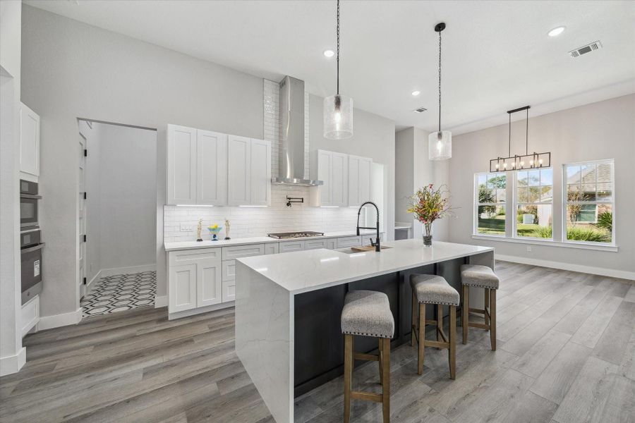 Featuring the Kitchen from the Staircase. The Door to the Octagonal Tile Mud Room extends to the Laundry Room just beyond.  7" Doors throughout with one leading to the Mud Room, and then one from the Mud Room to the Laundry Room