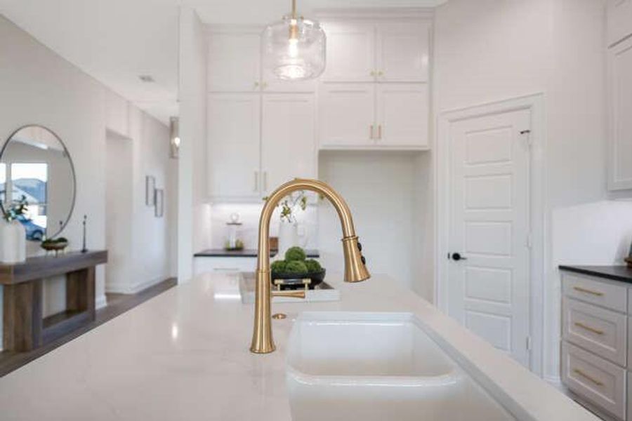 Kitchen view of white cabinets and pendant lighting Kitchen view of white cabinets and pendant lighting