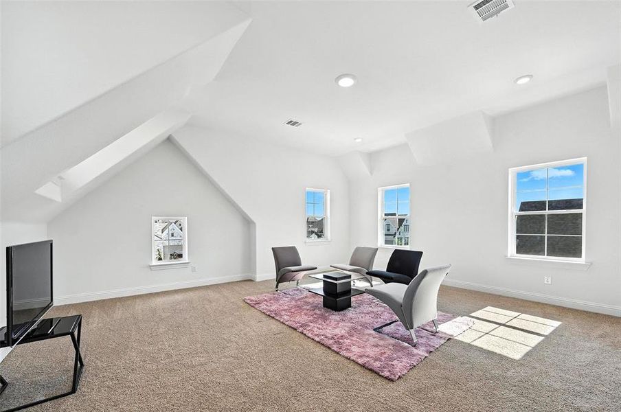 Sitting room featuring carpet floors, a skylight, lofted ceiling, and recessed lighting