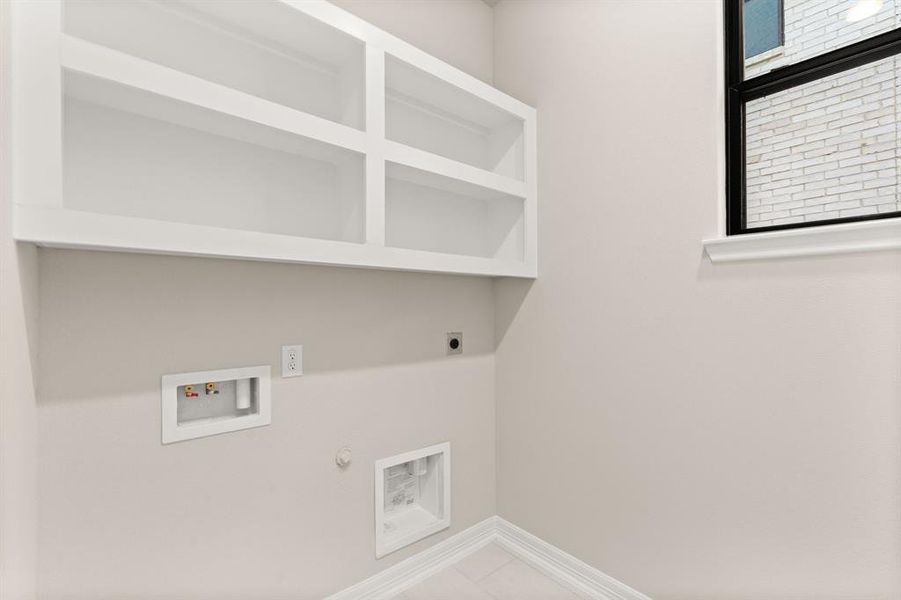 The laundry room layout is carefully planned for optimal workflow with designated areas for washing, drying, and storing.