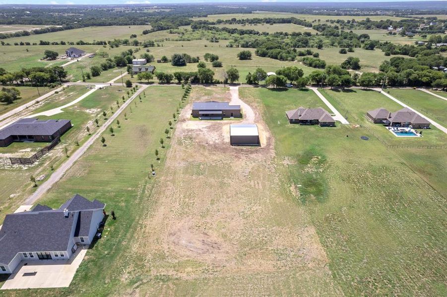 Birds eye view of property featuring a rural view