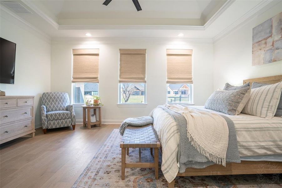 Bedroom featuring multiple windows, recessed lighting, wood finished floors, ceiling fan, and crown molding Bedroom featuring multiple windows, recessed lighting, wood finished floors, ceiling fan, and crown molding