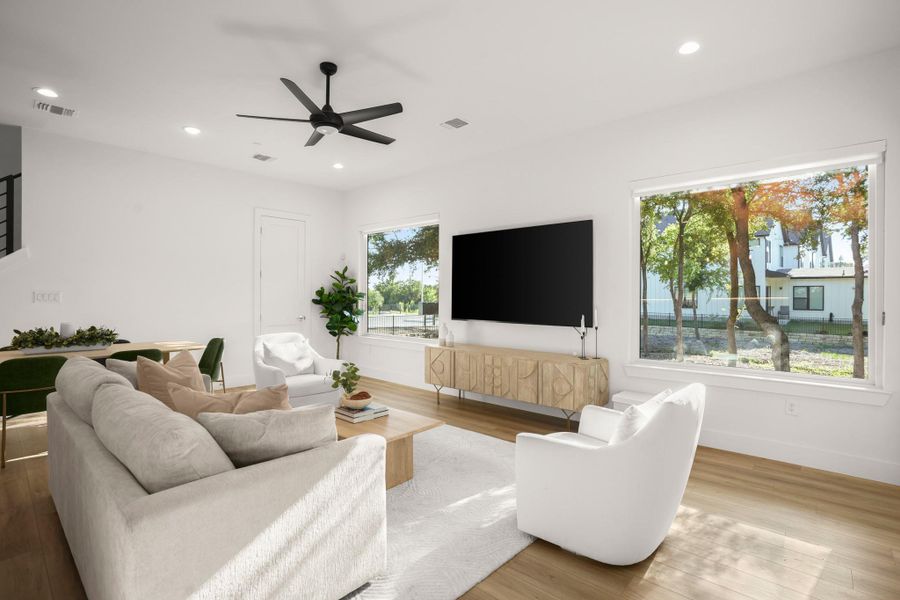 Luminous open floor plan living wrapped in picture windows that frame peaceful tree filled views and grace the interior with peaceful natural light throughout the day. Luminous open floor plan living wrapped in picture windows that frame peaceful tree filled views and grace the interior with peaceful natural light throughout the day.