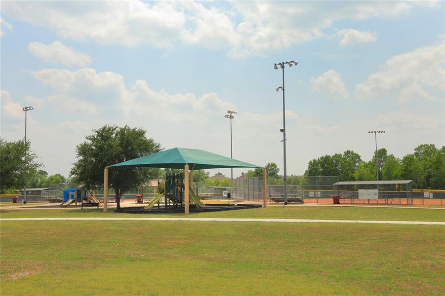 View of property's community featuring a lawn and a playground