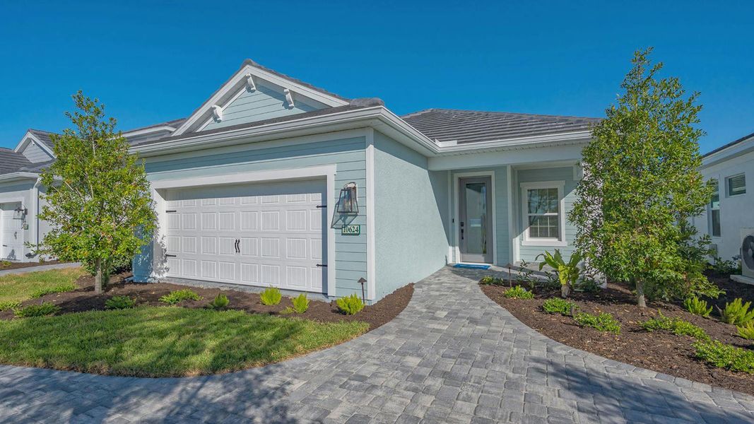 Front exterior of a new home in Boca Royale Golf & Country Club Real Estate and Homes for Sale in Englewood, FL - Neal Communities, Englewood, FL, highlighting curb appeal (Image 2). Front exterior of a new home in Boca Royale Golf & Country Club Real Estate and Homes for Sale in Englewood, FL - Neal Communities, Englewood, FL, highlighting curb appeal (Image 2).