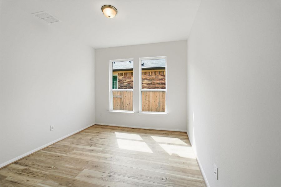 Empty room featuring light wood-type flooring and baseboards