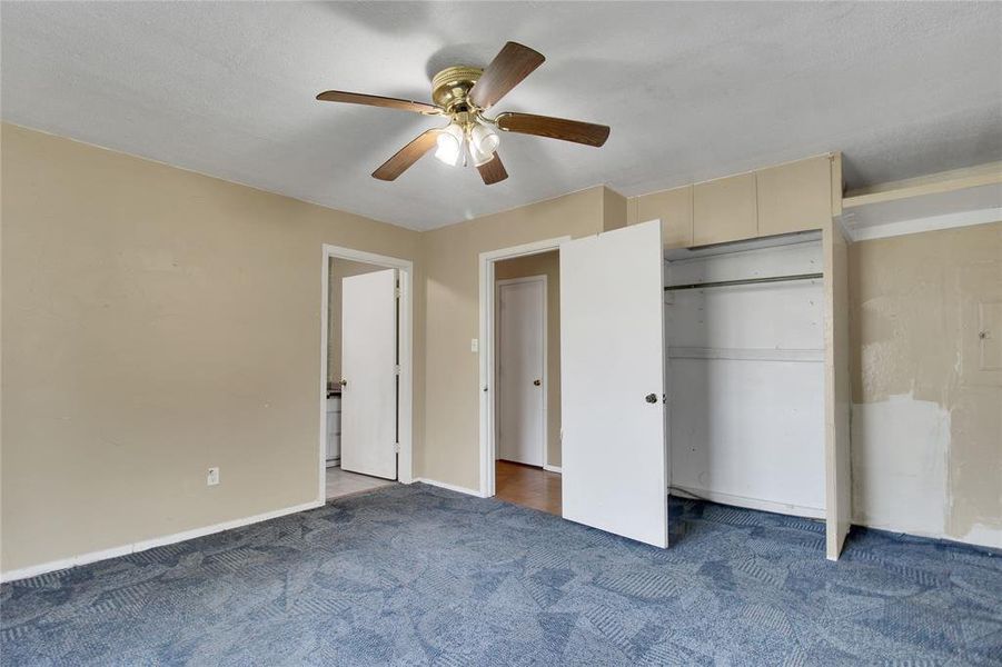 Unfurnished bedroom with a ceiling fan, carpet floors, and a closet Unfurnished bedroom with a ceiling fan, carpet floors, and a closet