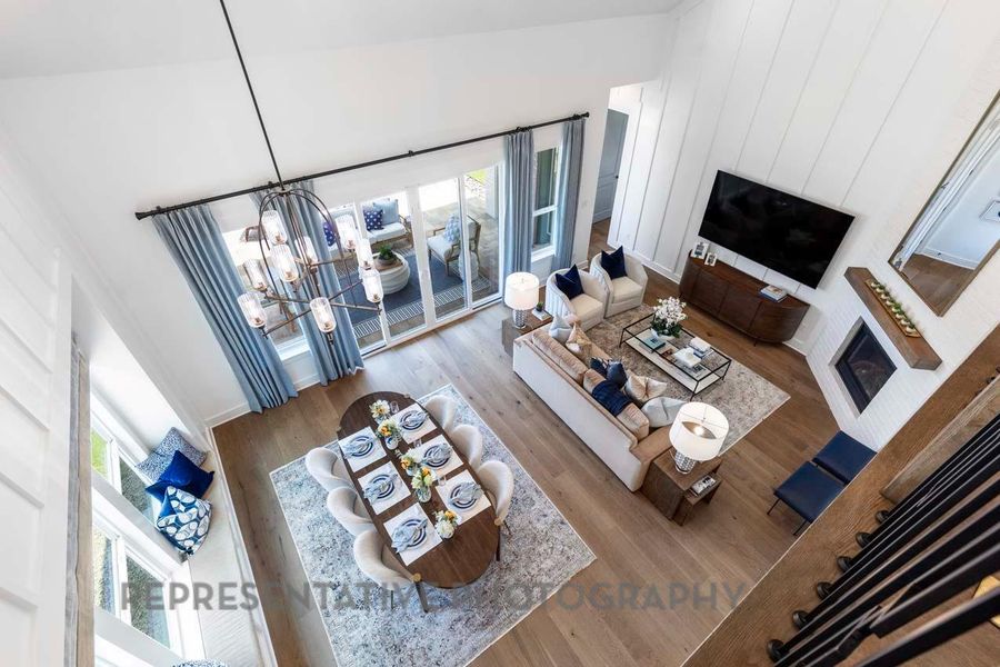 Living room featuring a fireplace, a chandelier, and wood finished floors
