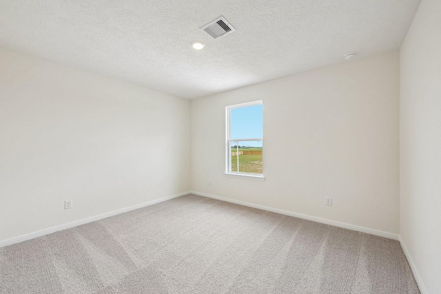 This secondary bedroom offers comfort and style with plush carpeting, neutral paint tones, recessed lighting, large window, and a generously sized closet.