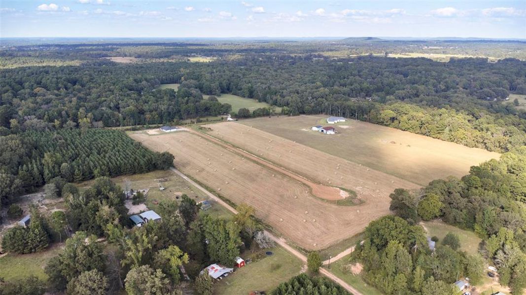 Aerial view of property and surrounding area featuring a forest and rural landscape Aerial view of property and surrounding area featuring a forest and rural landscape